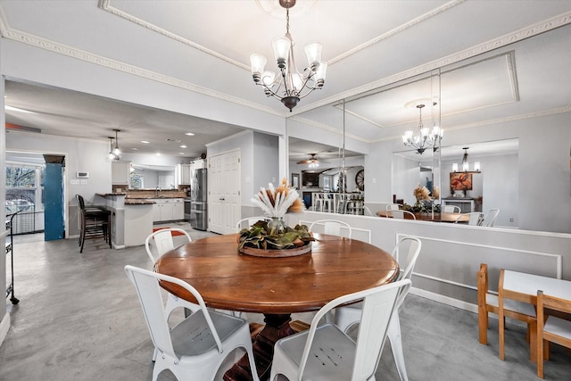 dining area with ceiling fan with notable chandelier, ornamental molding, and sink