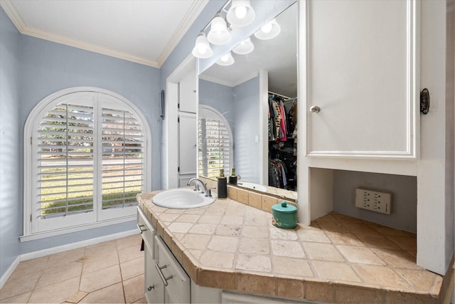 bathroom with ornamental molding, vanity, tile patterned floors, and a healthy amount of sunlight