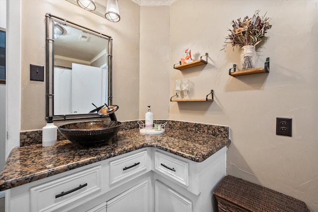 bathroom featuring vanity and ornamental molding