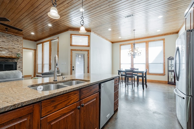 kitchen with appliances with stainless steel finishes, sink, decorative light fixtures, light stone counters, and wood ceiling