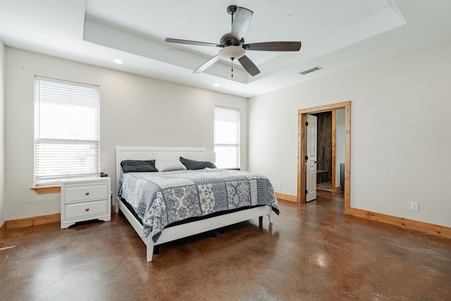 bedroom featuring ceiling fan and a tray ceiling