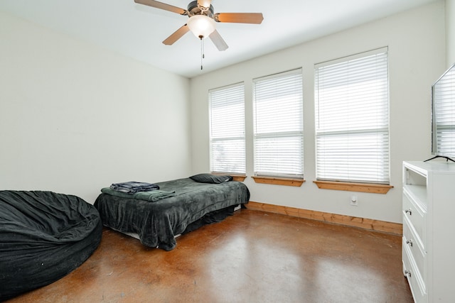 bedroom with concrete flooring and ceiling fan