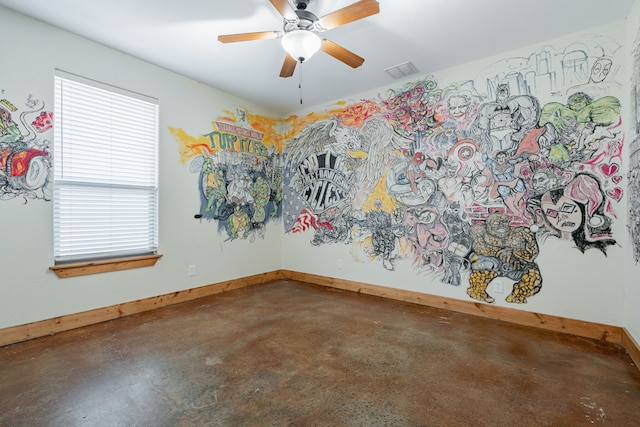 empty room featuring ceiling fan and concrete flooring