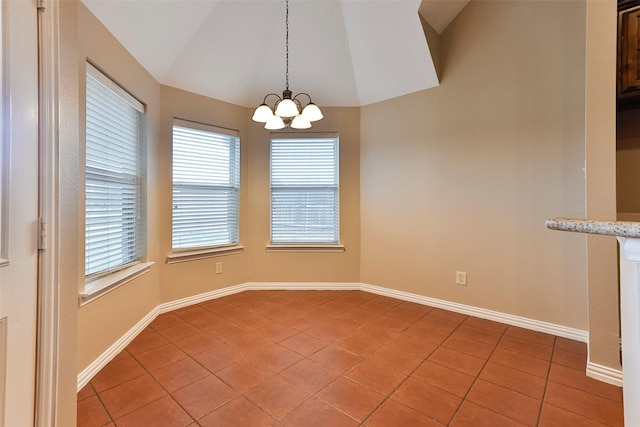 tiled spare room featuring vaulted ceiling and a notable chandelier