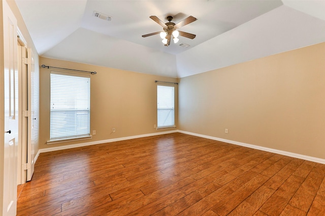 unfurnished room with hardwood / wood-style flooring, vaulted ceiling, and ceiling fan