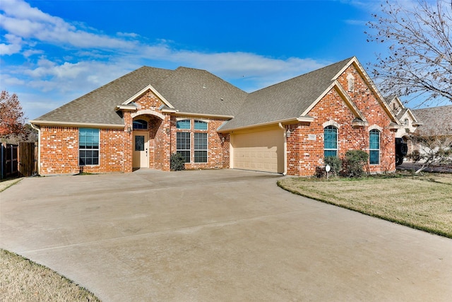 view of front of property with a garage and a front lawn