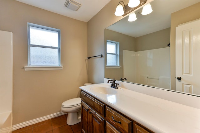 bathroom with tile patterned flooring, vanity, and toilet