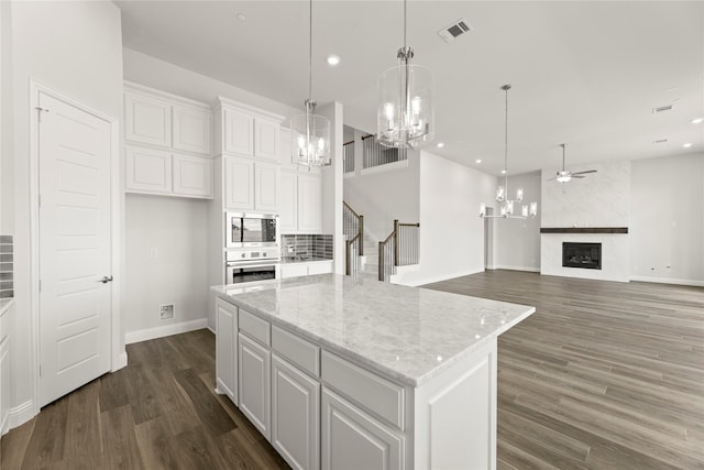 403 Spoonbill Rd, Sunnyvale, TX 75182 - kitchen with stainless steel appliances, a chandelier, white cabinets, dark wood finished floors, and ceiling fan