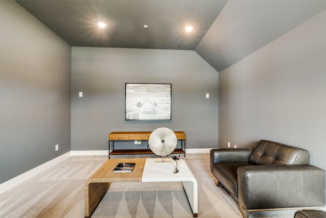 sitting room with light colored carpet and lofted ceiling