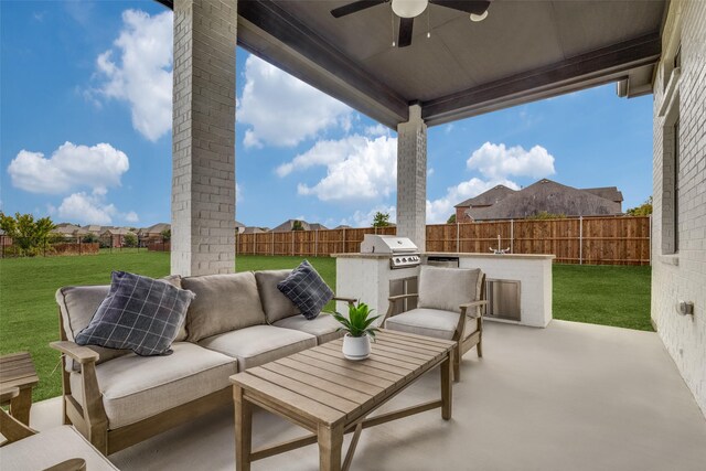 view of patio / terrace featuring area for grilling, ceiling fan, exterior kitchen, and an outdoor living space