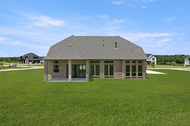 403 Spoonbill Rd, Sunnyvale, TX 75182 - rear view of house with a patio area, a yard, a shingled roof, and brick siding