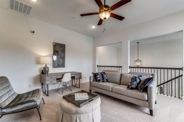 carpeted living room featuring ceiling fan