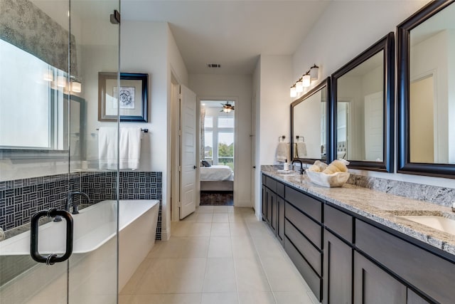 bathroom with vanity, a bathtub, tile patterned floors, and ceiling fan