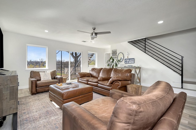 living room with hardwood / wood-style floors and ceiling fan