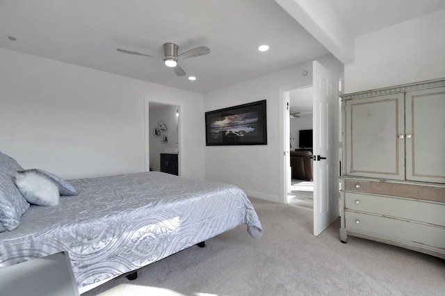 carpeted bedroom with beamed ceiling, connected bathroom, and ceiling fan