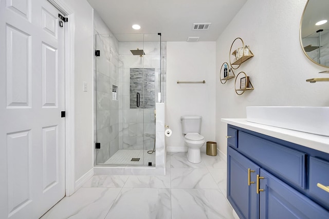 bathroom featuring vanity, an enclosed shower, and toilet