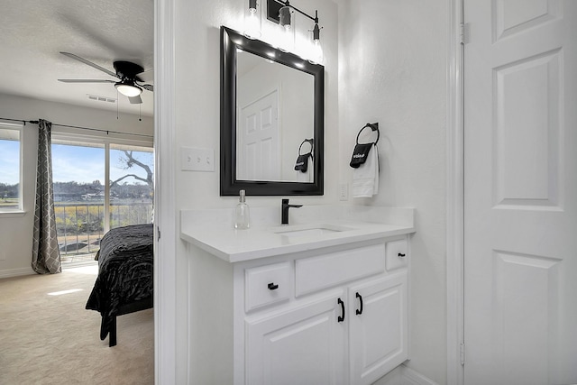 bathroom featuring ceiling fan, a textured ceiling, and vanity