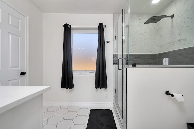 bathroom featuring tile patterned flooring, vanity, and a shower with door