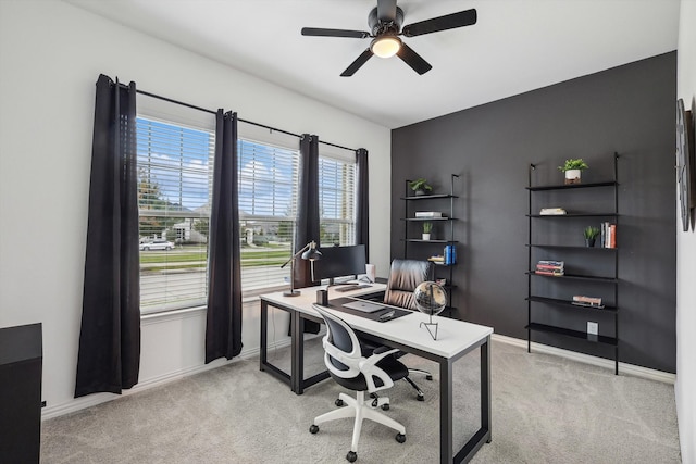 carpeted office space with ceiling fan