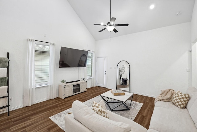 living room with dark hardwood / wood-style flooring, high vaulted ceiling, and ceiling fan