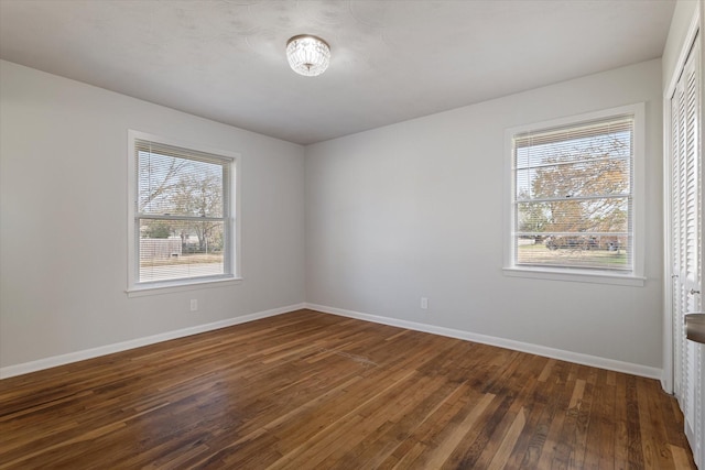 spare room with dark wood-type flooring