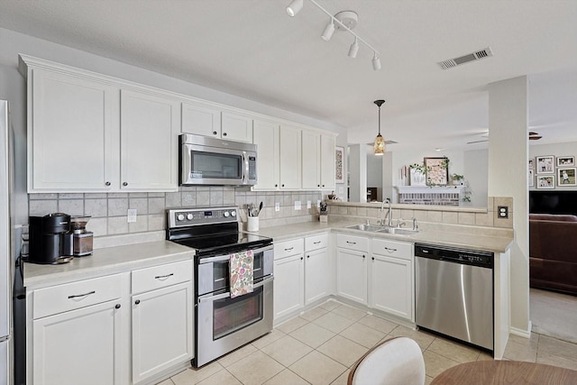 kitchen featuring white cabinetry, appliances with stainless steel finishes, and sink