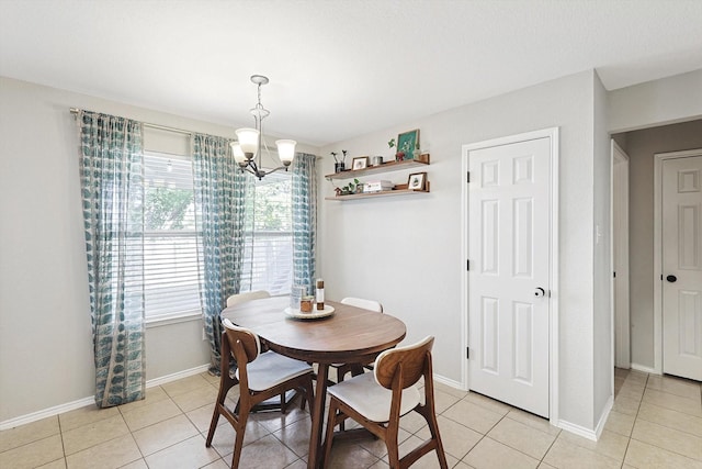 tiled dining area with a chandelier