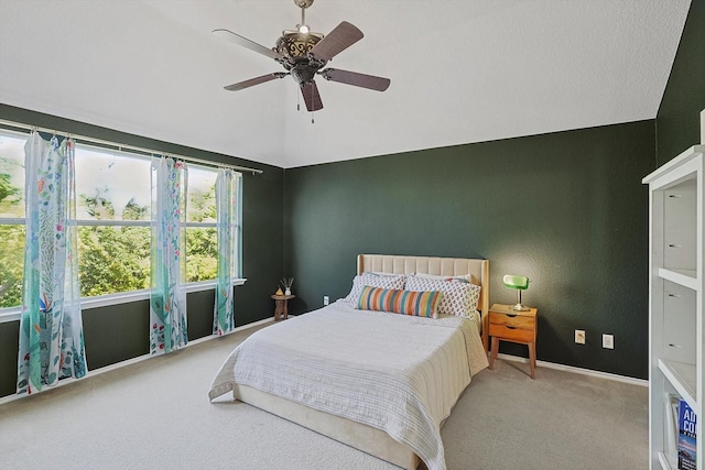 bedroom with light carpet, vaulted ceiling, and ceiling fan