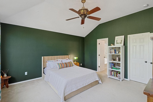 bedroom featuring ensuite bathroom, carpet, lofted ceiling, and ceiling fan