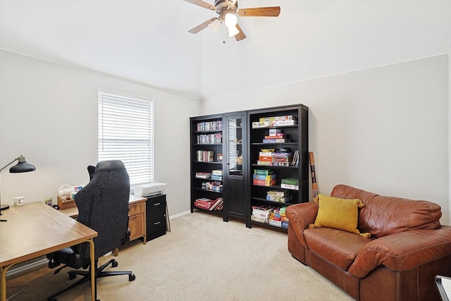 home office featuring lofted ceiling, light carpet, and ceiling fan