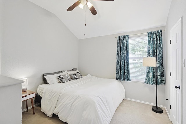 bedroom featuring ceiling fan, light colored carpet, and vaulted ceiling