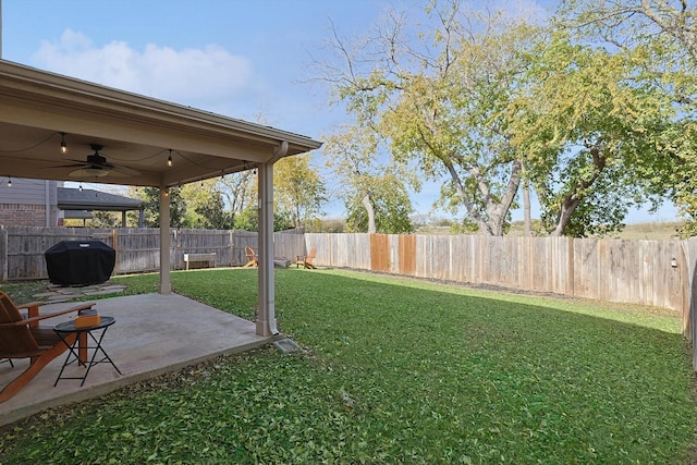 view of yard with ceiling fan and a patio area