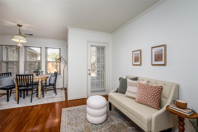 living room with dark wood-type flooring and crown molding