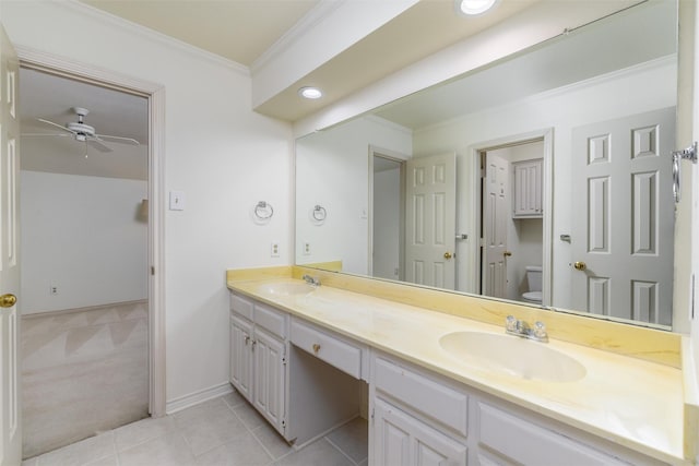 bathroom with toilet, tile patterned floors, vanity, ornamental molding, and ceiling fan