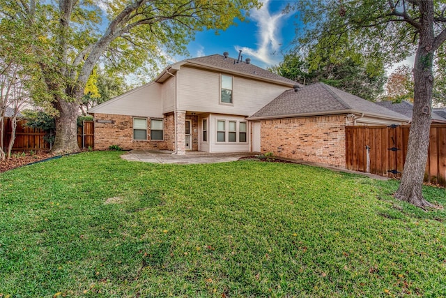 back of property featuring a patio area and a yard