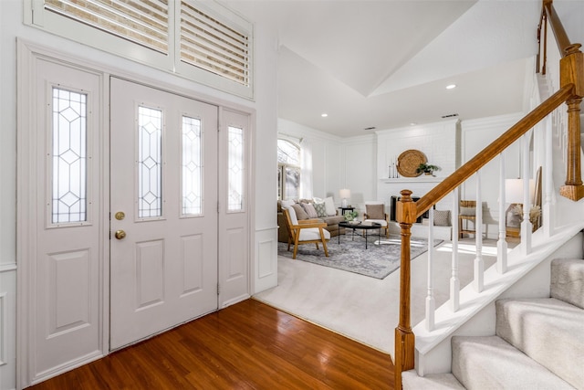 entrance foyer featuring lofted ceiling and hardwood / wood-style flooring