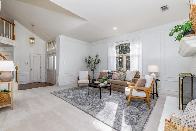 living room featuring lofted ceiling, light colored carpet, and a healthy amount of sunlight