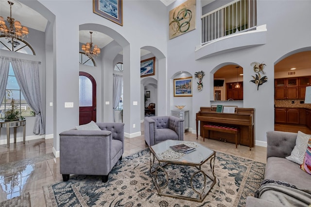 living room with a towering ceiling and an inviting chandelier