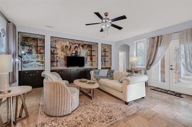 living room featuring french doors, light tile patterned floors, and ceiling fan