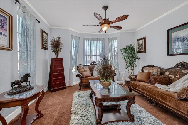 sitting room with carpet flooring, ceiling fan, and crown molding