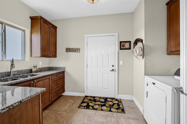 laundry area featuring cabinets, washer / dryer, light tile patterned floors, and sink