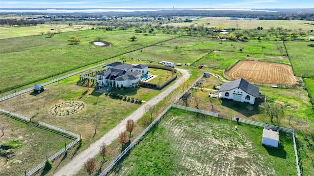 birds eye view of property with a rural view