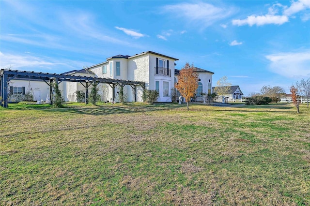 exterior space featuring a front yard and a pergola