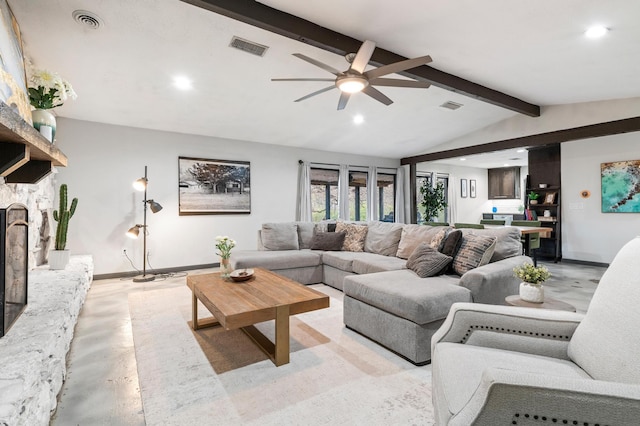 living room featuring ceiling fan, vaulted ceiling with beams, and a fireplace