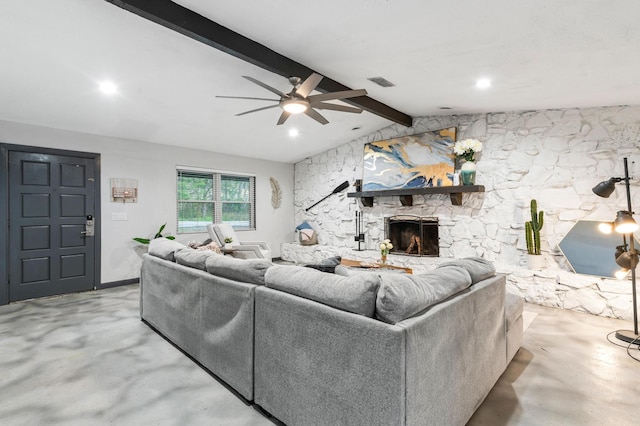 living room with vaulted ceiling with beams, ceiling fan, and a fireplace