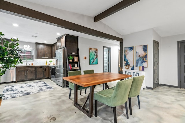 dining area with vaulted ceiling with beams and sink