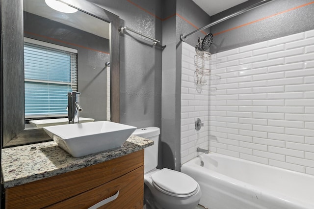 full bathroom with tiled shower / bath combo, vanity, and toilet