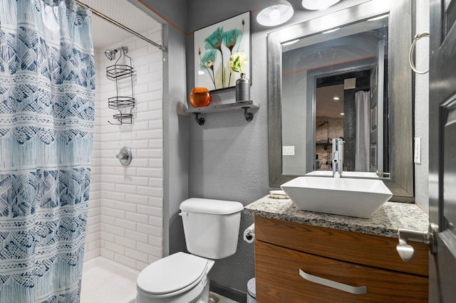 bathroom with toilet, vanity, and a shower with shower curtain