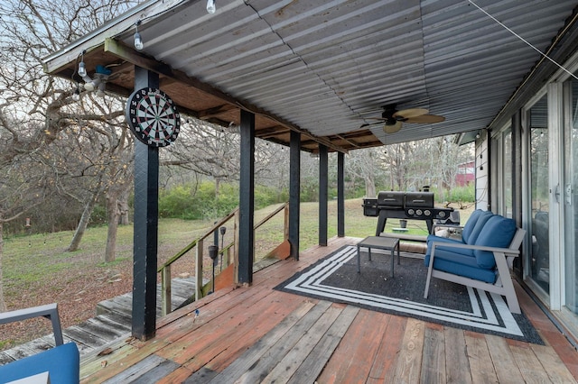 wooden terrace with grilling area and ceiling fan