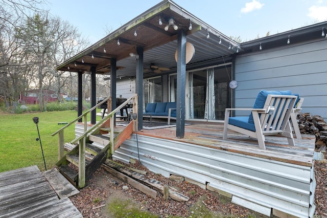 deck featuring a lawn, outdoor lounge area, and ceiling fan